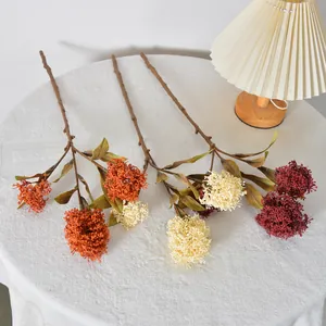 Three-pronged artificial Skimmia berry branches in autumn colors for home floral decor