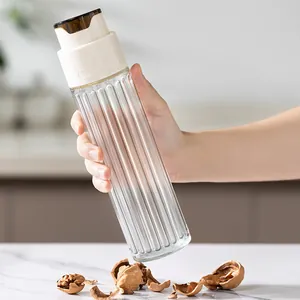 Elegant clear fluted glass oil bottle with automatic opening white lid for kitchen sauce