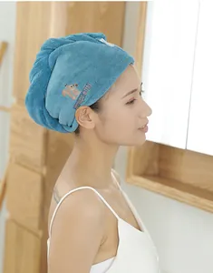 Side view of woman wearing blue microfiber hair drying cap with squirrel embroidery