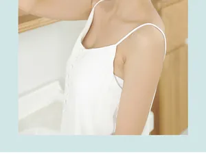 Close-up detail view of a white sleeveless button-front camisole worn by a model