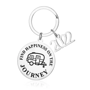 Close-up detail of engraved stainless steel keychain with camper van and 2022 charm