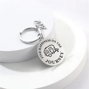Detailed macro view of an engraved stainless steel keychain with camper van motif