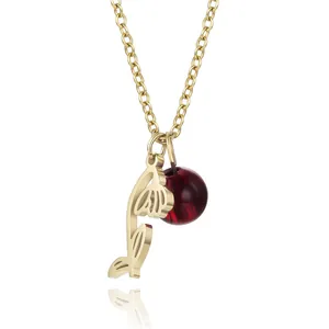 Close-up detail of gold titanium steel necklace with hollow flower and dark red bead.