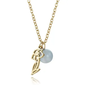 Detailed close-up of a gold titanium steel necklace featuring hollow flower and blue bead pendants