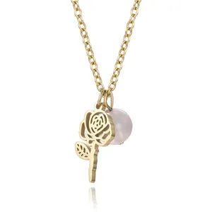 Close-up of an elegant gold hollow rose pendant necklace featuring a delicate pink pearl charm