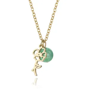 Detailed view of a gold stainless steel cutout flower pendant with a green bead charm.