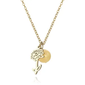 Detailed macro view of a gold hollow flower pendant necklace with a yellow bead charm.