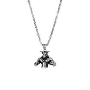 Macro view of muscular bull pendant on stainless steel box chain for hip hop style