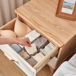 Clear plastic drawer dividers for underwear and sock storage inside wooden drawer