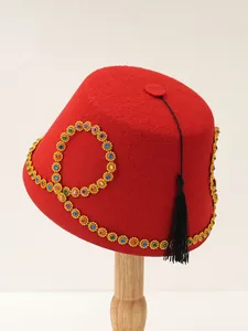 Detailed view of luxury red felt Turkish fez hat with colorful gems and black tassel