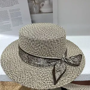 Elegant vintage flat top woven straw sun hat for women featuring a stylish paisley ribbon bow