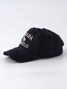 Close-up of vintage washed denim baseball cap with Canada embroidery and distressed details