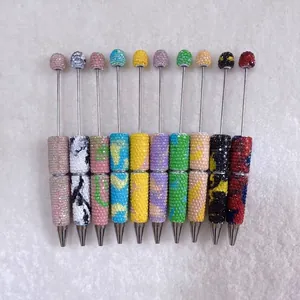 Detailed view of colorful rhinestone-covered DIY beadable pens in various candy colors