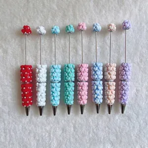 Detailed view of colorful sugar heart beaded ballpoint pens with pearl accents