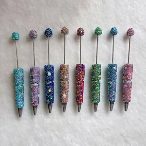 Close-up detail of luxury handmade colorful rhinestone pens with sparkling crystal stones