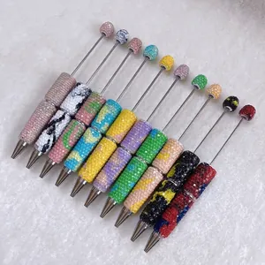 Detail shot of colorful handmade rhinestone ballpoint pens in various candy colors.