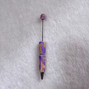 Detailed view of handmade rhinestone ballpoint pen with vibrant candy-colored beads