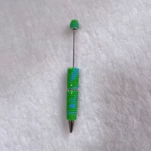 Close-up of candy-colored rhinestone ballpoint pen with handcrafted crystal detail