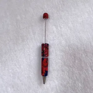 Handmade ballpoint pen with red and blue rhinestones and sleek metal rod design