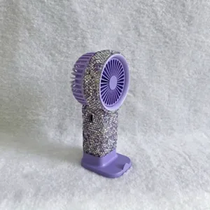 Draagbare paarse mini-ventilator met strassteentjes en oplaaddock voor op bureau