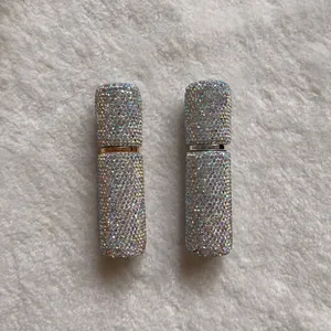 Close-up of 10ml portable perfume atomizer bottles covered in glittering AB rhinestones.