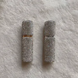Macro detail of luxury 10ml rhinestone perfume atomizers with gold and silver accents