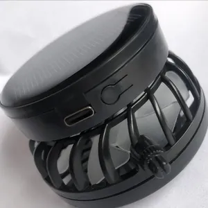 Detailed macro view of black solar-powered hat fan showing USB charging port and guard
