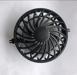 Detailed macro view of a black circular cooling fan attachment for summer solar hats