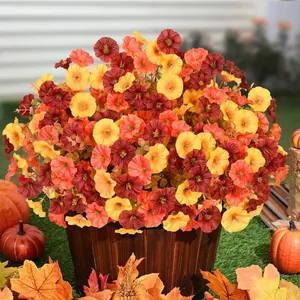 Close-up detail of vibrant autumn artificial petunias arranged in a rustic wooden bucket