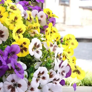 Close-up of vibrant purple, yellow, and white artificial pansy silk flower bouquet.