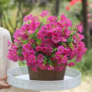Vibrant magenta artificial morning glory silk flower bouquet in a pot on a white tray