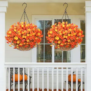 Vibrant orange artificial petunias in coconut liner hanging baskets on a white porch