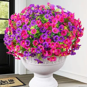 Vibrant purple and pink artificial petunias in a white decorative garden planter