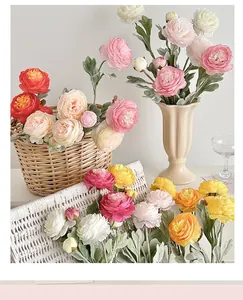 Close-up detail of colorful 3-head artificial Ranunculus silk flowers in a home decor setting