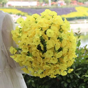 Detail view of vibrant yellow artificial morning glory silk flower bouquet for home decor