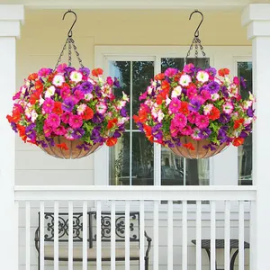 Set of two hanging baskets with vibrant artificial petunias and greenery on a white porch.