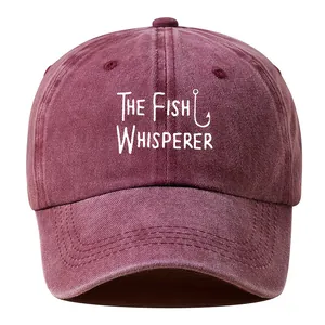 Detailed view of 'The Fish Whisperer' graphic on a maroon washed vintage cotton cap.