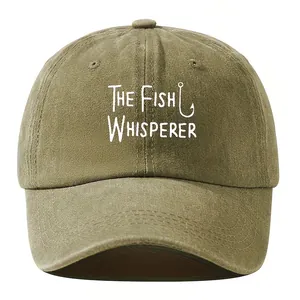 Close-up of a washed vintage baseball cap featuring a white Fish Whisperer slogan print.