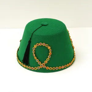 Green felt Fez hat with colorful gemstones, gold trim decoration, and a black tassel.