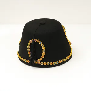 Exotic black felt Fez hat featuring golden gemstone trim and a dangling black tassel detail.