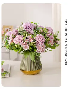 Elegant purple artificial hydrangea bouquet in a green ribbed vase with gold base detail.