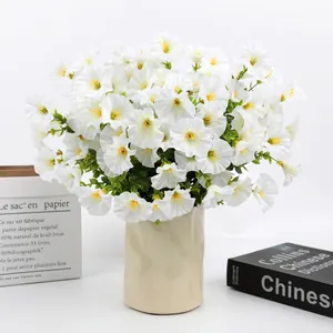Lush white artificial morning glory flowers in a cream wavy ceramic vase for home decor