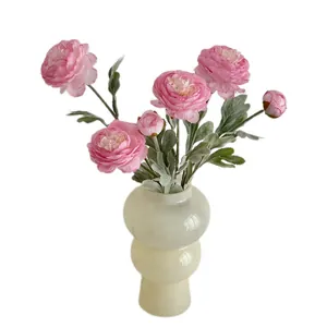Elegant pink artificial Ranunculus bouquet in a cream bulbous vase for home decor.