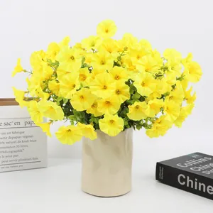 Realistic yellow artificial petunias in a ceramic vase for home decor setup