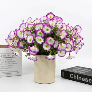 Artificial purple petunias with eucalyptus in a modern beige textured vase