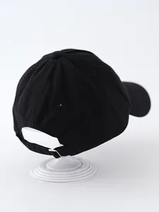 Detailed back view of a black cotton baseball cap with adjustable metal buckle strap