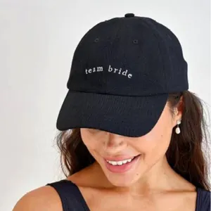 Stylish black baseball cap with white team bride embroidery for wedding parties.