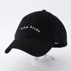 Black baseball cap featuring white "team bride" embroidery on the front.