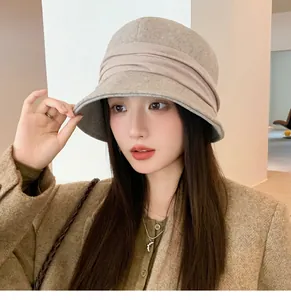 Detail of a vintage khaki felt bucket hat with pleated ribbon for autumn and winter.