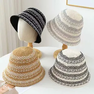 Selection of handcrafted breathable straw bucket hats featuring stylish striped patterns for summer